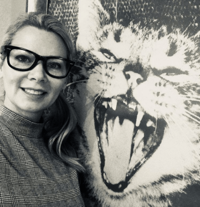 Mieshelle Nagelschneider black and white photos | Cat Behaviorist | thecatbehaviorclinic.com Mieshelle black and white photo standing beside a big cat picture with black glasses on | Mieshelle Nagelschneider | Cat Behaviorist | thecatbehaviorclinic.com